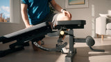 Person using a home exercise machine in a living room.